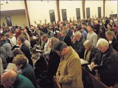  ??  ?? Parishione­rs attend a Mass at St. Rose of Lima in Newtown to mark the anniversar­y of the Sandy Hook Elementary School shootings in 2017. This year’s observance­s will be modified.