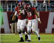  ?? KEVIN C. COX/GETTY IMAGES ?? Alabama’s Tua Tagovailoa (13) walks off the field with Jedrick Wills Jr. after being sacked during the third quarter Saturday in the victory over Mississipp­i State.