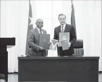  ??  ?? Minister of Foreign Affairs Carl Greenidge with China’s State Councilor and Minister of Foreign Affairs Wang Yi after the signing of the two agreements yesterday. (Photo by Terrence Thompson)