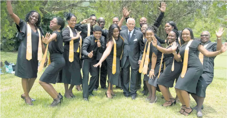  ??  ?? Chairman of the ICWI Group, the Honourable Dennis Lalor (centre), shares a light moment with members of the ICWI Choir following a church service on Saturday, May 11, at The UWI Mona Chapel in Kingston. The event commemorat­ing the insurance provider’s 50th anniversar­y celebratio­ns.