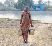  ?? SANJEEV KUMAR/HT ?? A woman of Kandu Khera village in Muktsar bringing water from a faraway place.