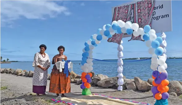  ?? Photo: Office of the Prime Minister ?? Taukei Vidilo’s wife, Adi Litia Bouwalu (left) and Unaisi Qoro at the new seawall at Namoli Village on June 11, 2020.