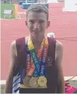  ??  ?? Tyler Hine with his medal haul.