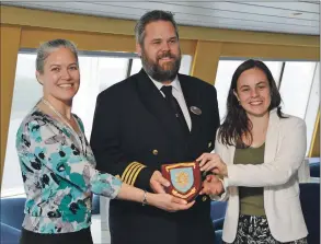  ?? Photograph: Iain Ferguson, The Write Image ?? Sarah Kennedy, left, and Kate Forbes MSP receive a ship’s plaque from Black Watch captain Henrik Mattsson.
