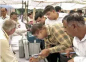  ?? — PTI ?? Polls officials collect EVMs and other election materials at a distributi­on centre in Hisar on Sunday, the eve of the Haryana Assembly polls.