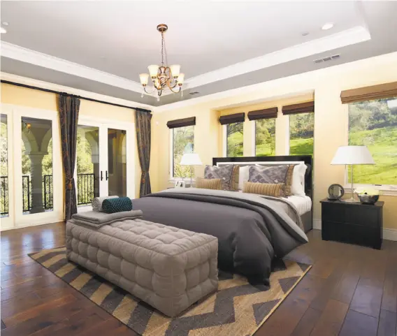  ?? PHOTOS BY DAVIDON HOMES ?? The master suite at the Tuscan-inspired home has a coffered ceiling and a fireplace. The five-bedroom is in the Highlands of Los Gatos and is now offered at $4,698,000.