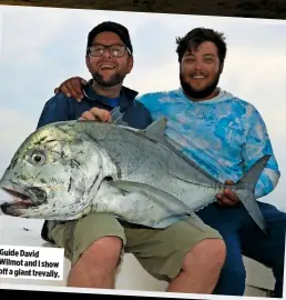  ??  ?? Guide David Wilmot and I show off a giant trevally.