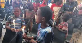  ??  ?? IN SOLIDARITY: Gauteng children light candles at Barnato Park High School in Berea as they commemorat­e Africa Week.