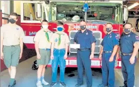  ?? COURTESY OF KEITH BOUDREAU ?? Troop 12 scouts Vincent Soubbotin, Lucas Gallo and Kyle Mabie present gift cards to members of the Leominster Fire Department, including Lt. Chris Cameron, Lt. Bryan LeBlanc, and Lt. Robert Penning.