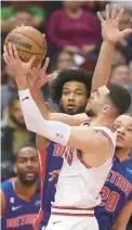  ?? JOHN J. KIM/CHICAGO TRIBUNE ?? Bulls guard Zach LaVine drives for two points against Pistons forward Kevin Knox (20) in the first quarter Friday at the United Center.