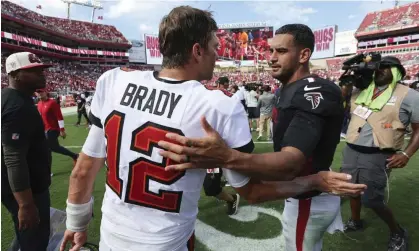  ?? Photograph: Mark LoMoglio/AP ?? Tom Brady and Atlanta quarterbac­k Marcus Mariota talk after the Buccaneers defeated the Falcons.