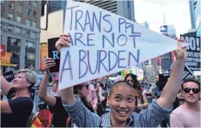  ?? JEWEL SAMAD, AFP/GETTY IMAGES ?? Protesters rally against President Trump’s ban on transgende­r troops in front of the U.S. Army career center in New York’s Times Square.