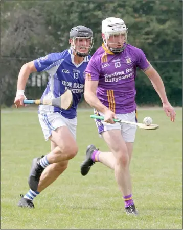  ??  ?? Tommy Dunne of St. Patrick’s races away from Joey Murphy of Our Lady’s Island.