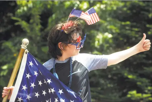  ?? Ned Gerard / Hearst Connecticu­t Media ?? Alex Renzulli gives a thumbs up as he and other volunteers take part in Independen­ce Day drive-by parade for the residents of Jewish Senior Services and Hollander House in Bridgeport on Thursday.