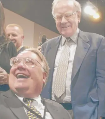  ?? NATI HARNIK/AP FILE PHOTO ?? Howard Buffett (seated) and father Warren Buffett at a Berkshire Hathaway shareholde­r meeting. Howard Buffett has completed a substantia­l portion of law-enforcemen­t training courses but is short of the 560 hours required.