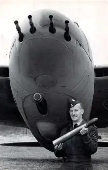  ?? ?? ■ An RAF corporal shows off the 57 mm shell carried by the Tsetse Mosquito – a formidable anti U-boat weapon.