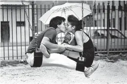  ?? PHIL GREER/CHICAGO TRIBUNE ?? Jose Sanchez and Norma Zamarron have the playground at Throop Street and Chicago Avenue all to themselves on a rainy Aug. 10, 1988.