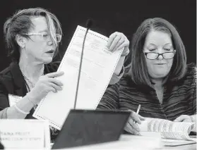  ?? Associated Press file photo ?? Canvassing Board members Betsy Benson, left, and Deborah Carpenter-Toye look over a ballot during hand-counting in Lauderhill, Fla., in 2018.