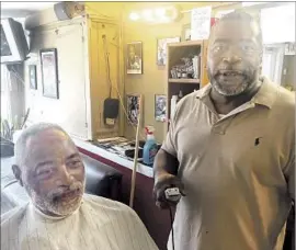  ?? Mark Barabak Los Angeles Times ?? “WE IN HERE are going to do everything we can to stop Donald Trump,” says Atlanta barber Karl Booker. Client Dwight Cole wants to hear more from Clinton.