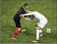  ?? THANASSIS STAVRAKIS — THE ASSOCIATED PRESS ?? Croatia’s Ivan Rakitic, left, and England’s Dele Alli get involved in a scuffle during the semifinal match between Croatia and England at the 2018soccer World Cup in the Luzhniki Stadium in Moscow, Russia, Wednesday.