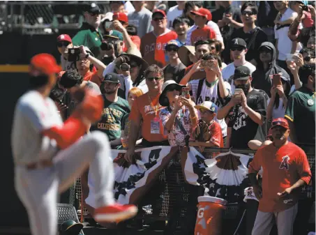  ?? Carlos Avila Gonzalez / The Chronicle ?? Whether hitting or pitching, Shohei Ohtani is a hit with fans who pointed their cameras his way as he warmed up Sunday.