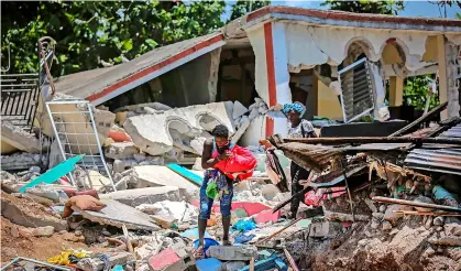  ?? Pic: AP Photo/joseph Odelyn ?? People recover their belongings from their homes destroyed in the 7.2-magnitude earthquake that struck at Camp-perrin, Les Cayes, Haiti, on Sunday, August 15