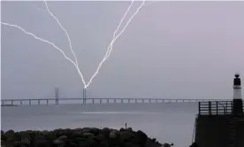  ?? Photograph: Johan Nilsson/AFP/Getty Images ?? Lightning strikes the Öresund Bridge between Sweden and Denmark earlier this year, as
seen from Malmö.