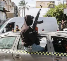  ?? AFP ?? A man wearing a mask and carrying a rifle sits in a car in Rafah, Gaza’s southernmo­st city