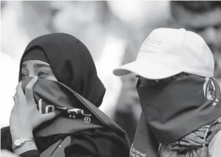  ?? Hassan Ammar, The Associated Press ?? Saudi women wait to watch the World Cup’s opening match — between Russia and Saudi Arabia — at Luzhniki Stadium in Moscow on Thursday.