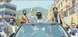  ?? AFP FILE ?? Hizbul Mujahideen chief Syed Salahuddin (centre) waves to supporters after a rally to mark the first death anniversar­y of militant Burhan Wani, in Muzaffarab­ad on Saturday.