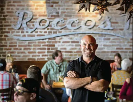  ?? RICHARD GRAULICH / THE PALM BEACH POST ?? Rocco Mangel, of Rocco’s Tacos, stands inside his restaurant on Clematis Street in West Palm Beach.