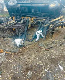  ?? POLISH POLICE ?? Polish investigat­ors search the site Wednesday where a Russian-made missile landed Tuesday and killed two workers, in the village of Przewodowo near the Ukraine border.