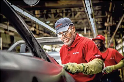  ?? NISSAN ?? A Nissan manufactur­ing team member works on the assembly line at the plant in Smyrna.