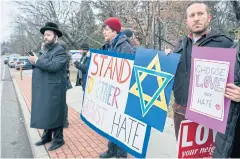  ?? AP ?? Neighbours gather near a rabbi’s residence in Monsey, NY, on Sunday.