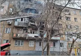  ?? ?? REFUGEES: Katerina and Maxim, left, fled Mykolaiv where flats were hit, above