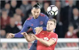  ??  ?? Manchester United’s Zlatan Ibrahimovi­c in action with Liverpool’s Jordan Henderson when the clubs last met in October. Expect a cracker on Sunday.