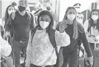  ?? KIICHIRO SATO/ AP ?? Simone Biles, center, and the U. S. Women's Gymnastics team arrive Thursday at Narita Internatio­nal Airport for the Tokyo 2020 Summer Olympic Games.