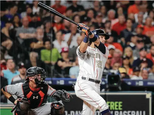  ?? Karen Warren / Houston Chronicle ?? Josh Reddick hits a two-run home run during the sixth inning against Baltimore. He topped that with a grand slam in the seventh.