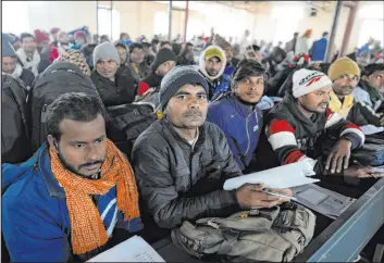  ?? Rajesh Kumar Singh The Associated Press ?? Skilled Indian constructi­on workers aspiring to be hired for jobs in Israel wait Thursday to submit their forms during a recruitmen­t drive in Lucknow, India.
