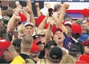  ?? JOE RAEDLE/GETTY ?? People react to the media as President Trump speaks.