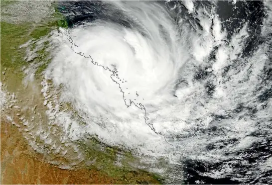  ?? PHOTO: SUPPLIED ?? A satellite photo shows Cyclone Debbie crossing the northeast Queensland coast near Airlie Beach yesterday. The Category 4 storm is packing winds of up to 260kmh.