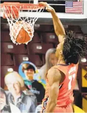  ?? JIM MONE AP ?? Illinois' Ayo Dosunmu has his second triple-double of the season to help the Illini trounce Minnesota.