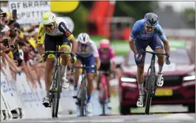  ?? THE ASSOCIATED PRESS ?? Stage winner Simon Clarke, right, sprints towards the finish line ahead of Netherland­s’ Taco van der Hoorn, left, during the fifth stage of the Tour de France cycling race over 157kilomet­ers (97.6miles) with start in Lille Metropole and finish in Arenberg Porte du Hainaut, France, Wednesday, July 6, 2022.