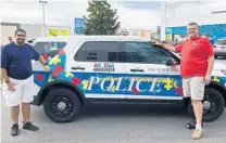  ?? PHOTO COURTESY OF DONNA LORMAN ?? Chris Gonzalez, left, and Drew Lorman stand in front of a Bal Harbour police car that is decorated for autism awareness.