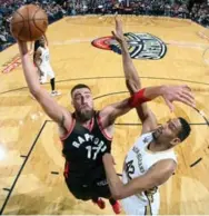  ?? LAYNE MURDOCH/GETTY IMAGES ?? Raptor Jonas Valanciuna­s drives to the rim past Alexis Ajinca for two of his 25 points, part of a milestone double-double.