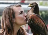  ?? RICHARD VOGEL — THE ASSOCIATED PRESS ?? In this photo falconer Alyssa Bordonaro gives a kiss to Dany her Harris’s Hawk during a day at work at the Museum of Modern Art in Los Angeles.
