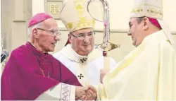  ??  ?? Successor Bishop Toal is presented with the diocesan pastoral staff in 2014 by Bishop Emeritus Joseph Devine, with Archbishop and Metropolit­an Philip Tartaglia looking on