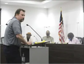  ?? Katie West • Times-Herald ?? Shane Dallas answers questions on bids recently opened during the Forrest City City Council meeting. Only two items from the list of unused fire equipment were bid on.