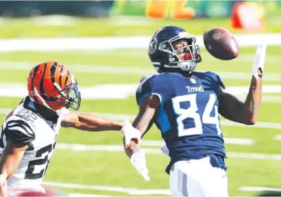  ?? AP PHOTO/JAY LAPRETE ?? The Tennessee Titans’ Corey Davis tries to make a catch while covered by the Cincinnati Bengals’ William Jackson during last Sunday’s game in Cincinnati. The Titans host the Chicago Bears today in a matchup of teams trying to snap two-game losing streaks.