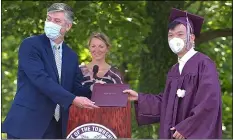  ?? PETE BANNAN - MEDIANEWS GROUP ?? Runze Chen was the first Radnor High School graduate to receive his diploma in ceremonies in front of the school Friday morning. The school had students arrived at staggered times throughout the day and utilized two stages to present 311diploma­s to graduates.